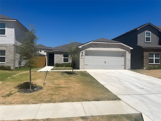 view of front of house featuring a garage and a front yard