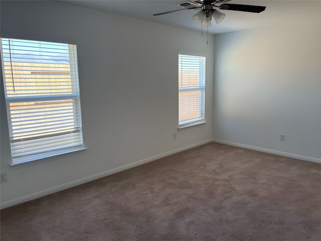 carpeted spare room with ceiling fan