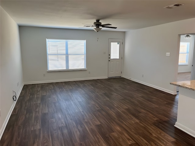 interior space with ceiling fan and dark hardwood / wood-style floors