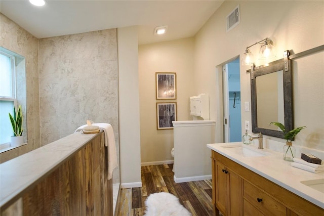 bathroom featuring hardwood / wood-style flooring, vanity, and toilet