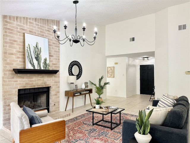 living room featuring lofted ceiling, a brick fireplace, light tile patterned floors, a textured ceiling, and a chandelier