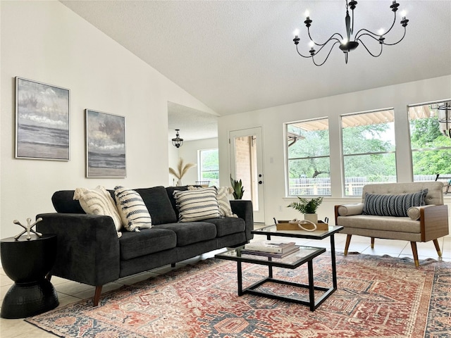 living room with tile patterned flooring, high vaulted ceiling, and a chandelier