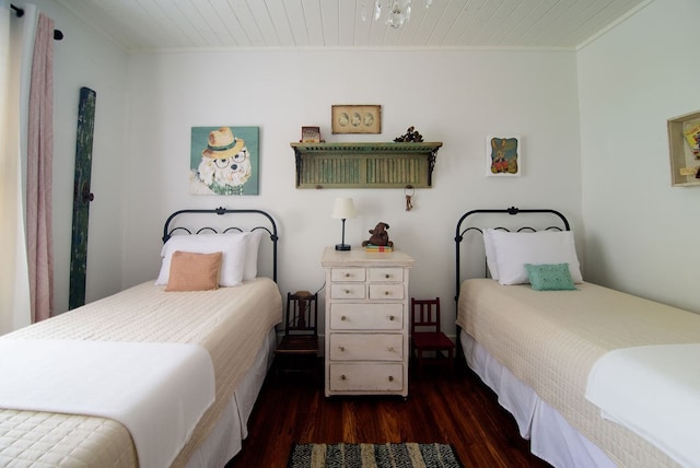 bedroom featuring ornamental molding and dark wood-type flooring