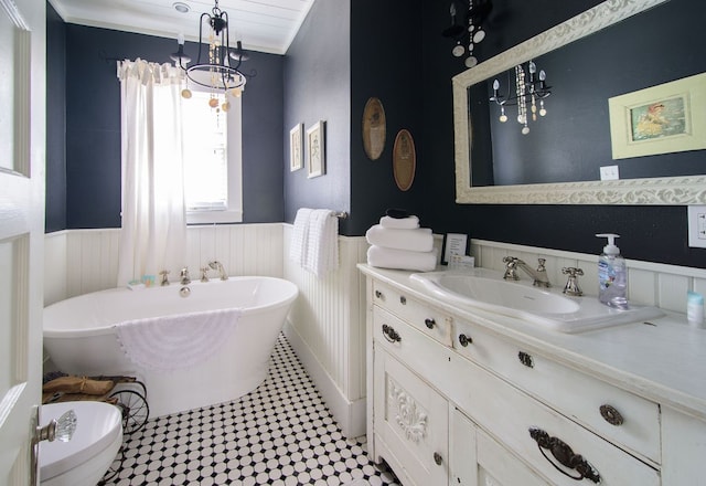 bathroom with large vanity, a bathing tub, toilet, a notable chandelier, and tile floors