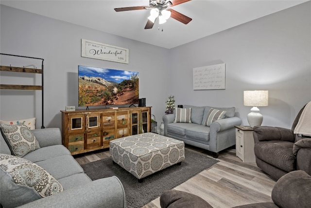 living room featuring light hardwood / wood-style floors and ceiling fan