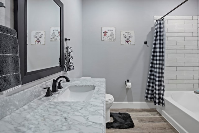 full bathroom with shower / tub combo, vanity, hardwood / wood-style flooring, and toilet