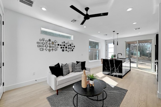 living room featuring light wood finished floors and visible vents