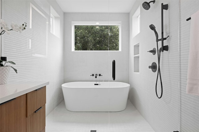 bathroom featuring tile patterned floors, vanity, and independent shower and bath