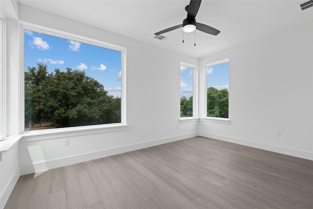 unfurnished room with ceiling fan and light hardwood / wood-style floors