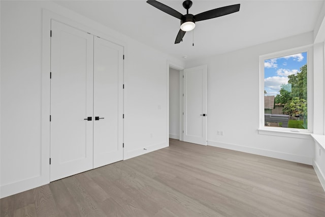 unfurnished bedroom featuring ceiling fan and light hardwood / wood-style floors