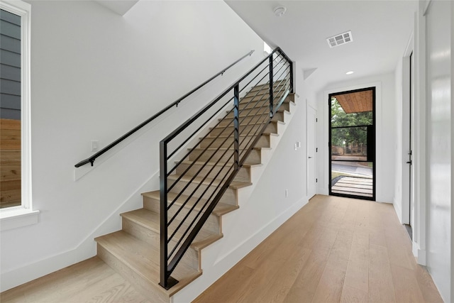 staircase with wood-type flooring