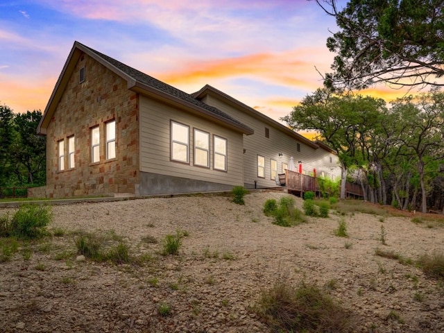 property exterior at dusk with a deck