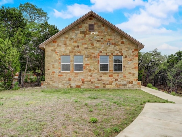 view of side of home with a lawn