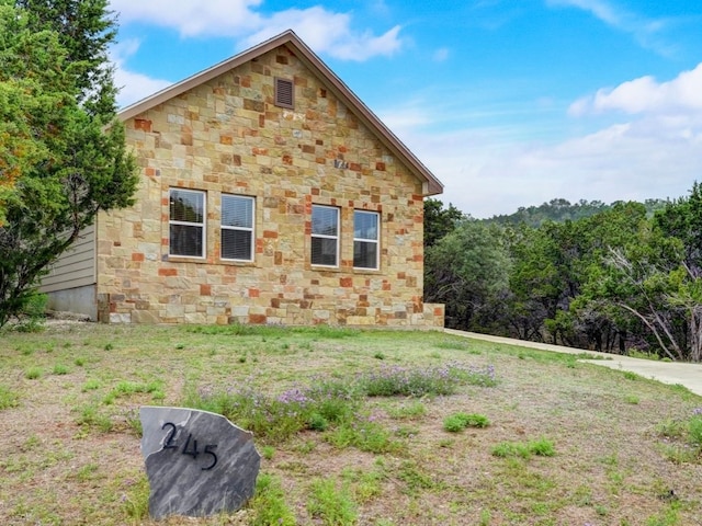 view of side of property featuring a yard