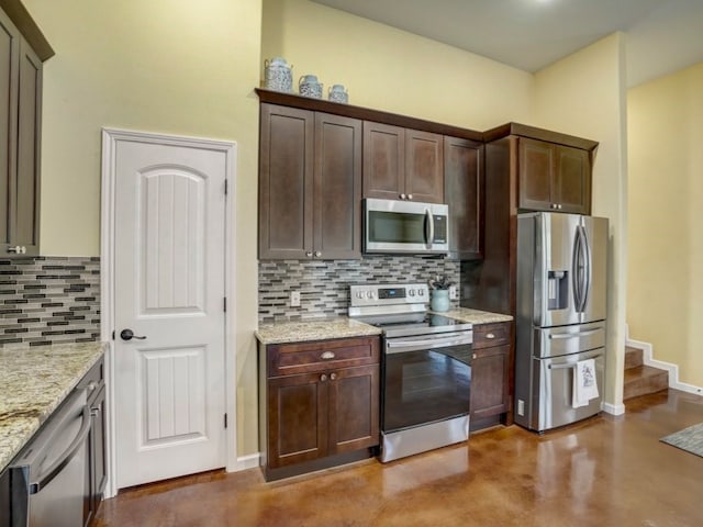 kitchen featuring backsplash, appliances with stainless steel finishes, dark brown cabinets, and light stone counters