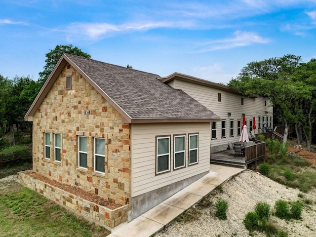 view of home's exterior featuring a wooden deck