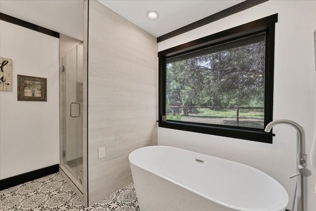 bathroom featuring tile patterned floors and shower with separate bathtub