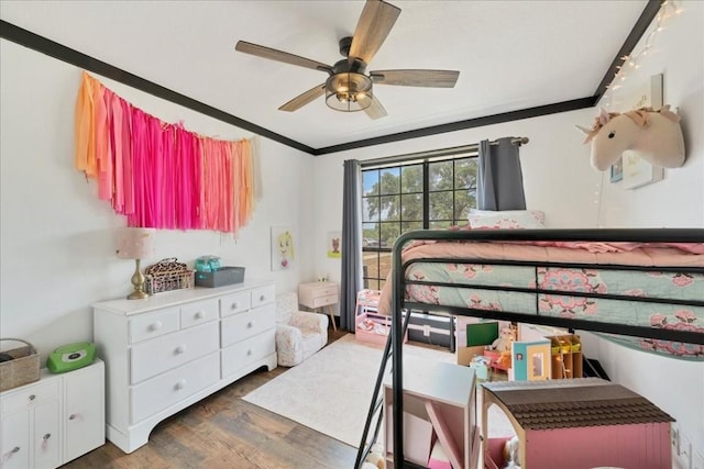 bedroom featuring ceiling fan, dark hardwood / wood-style flooring, and ornamental molding