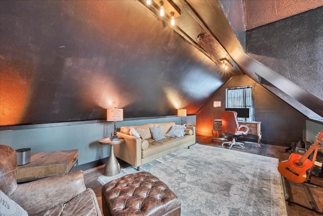 home theater with wood-type flooring and lofted ceiling