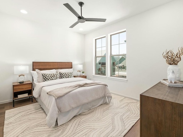 bedroom with ceiling fan and light wood-type flooring