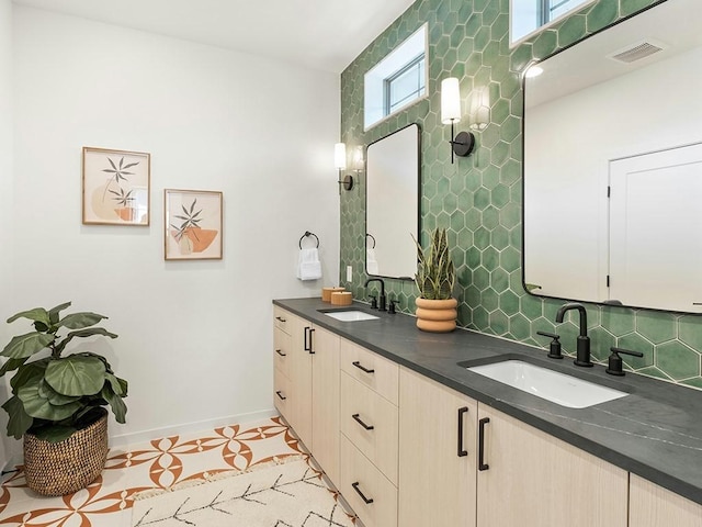 bathroom featuring vanity and backsplash