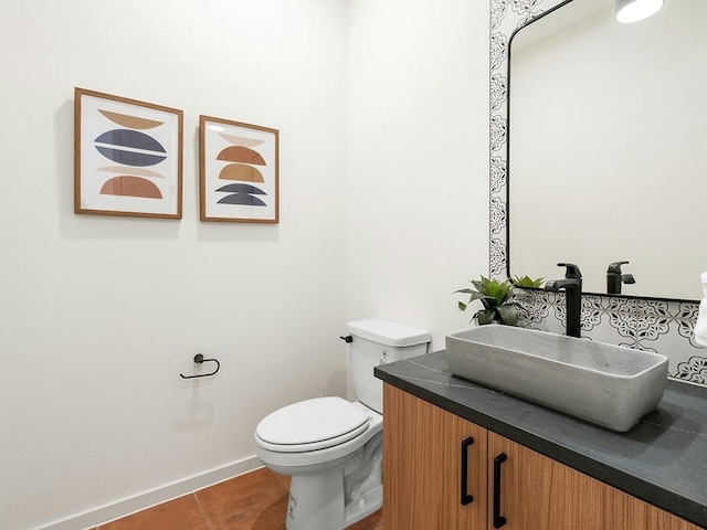 bathroom featuring vanity, tile patterned floors, and toilet