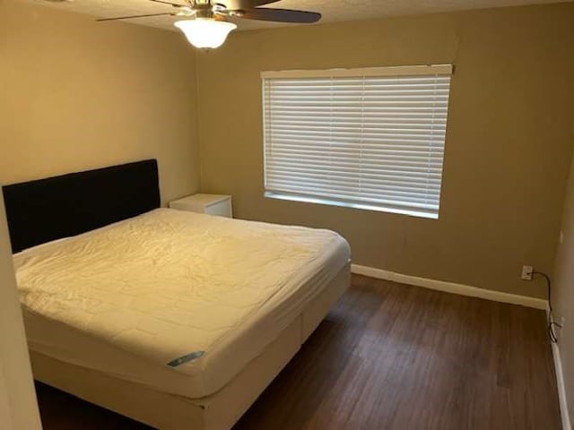 bedroom featuring dark hardwood / wood-style flooring and ceiling fan