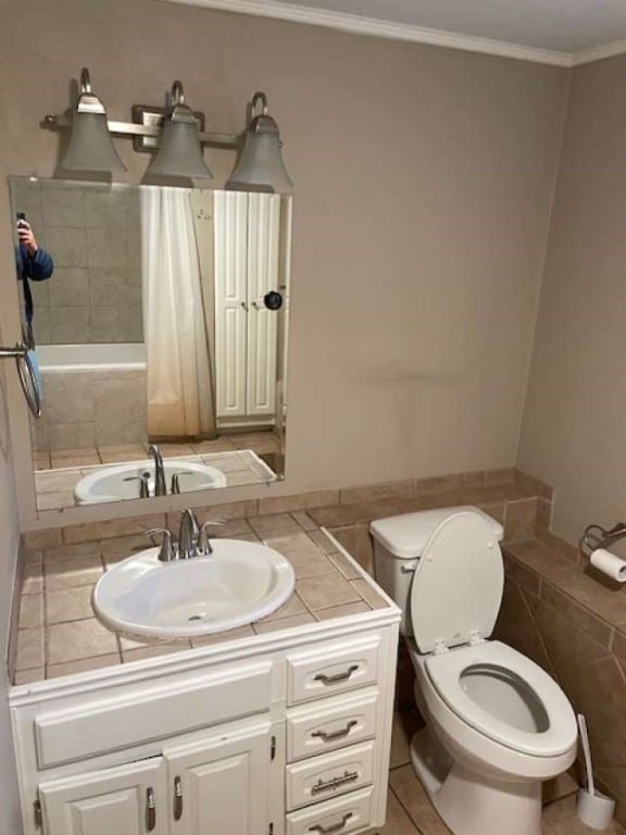 bathroom featuring vanity, crown molding, and toilet