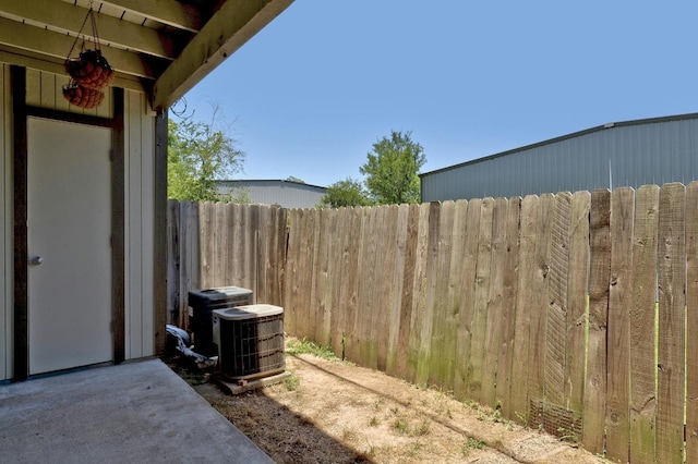 view of yard featuring central AC unit and a patio area