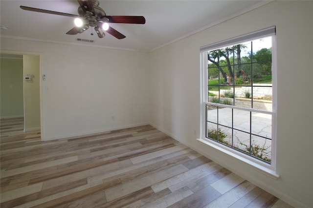 empty room featuring ceiling fan, ornamental molding, and light hardwood / wood-style flooring