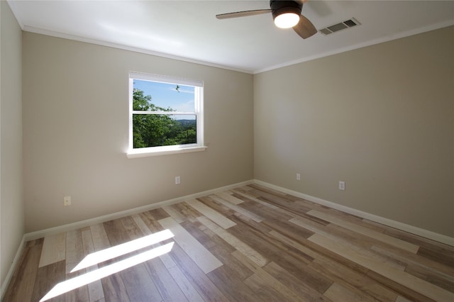 unfurnished room featuring light hardwood / wood-style floors, crown molding, and ceiling fan