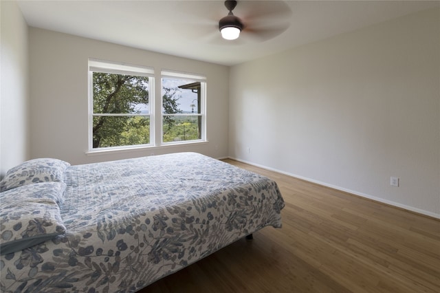 bedroom featuring dark wood-type flooring and ceiling fan