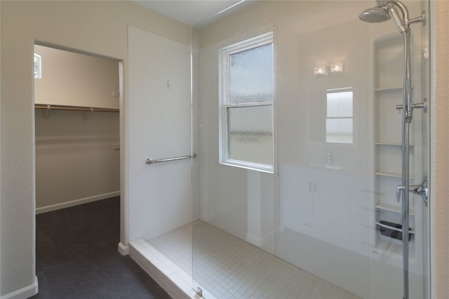 bathroom with tile patterned floors and a shower