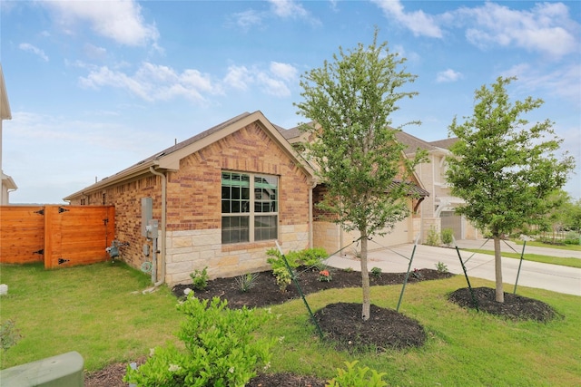 view of front of home with a front yard and a garage