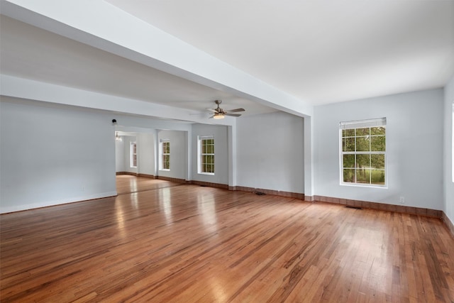 spare room with beam ceiling, ceiling fan, and hardwood / wood-style floors