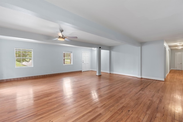 interior space featuring light hardwood / wood-style flooring, beam ceiling, and ceiling fan