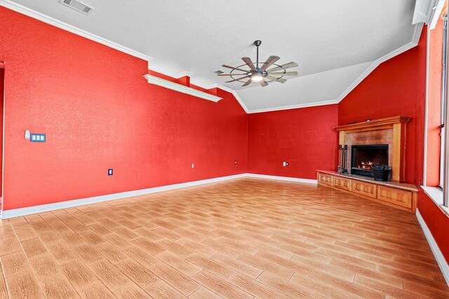 unfurnished living room with ceiling fan, vaulted ceiling, light hardwood / wood-style floors, and crown molding