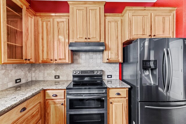 kitchen featuring backsplash, appliances with stainless steel finishes, and light stone countertops