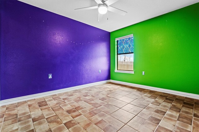 tiled spare room featuring ceiling fan