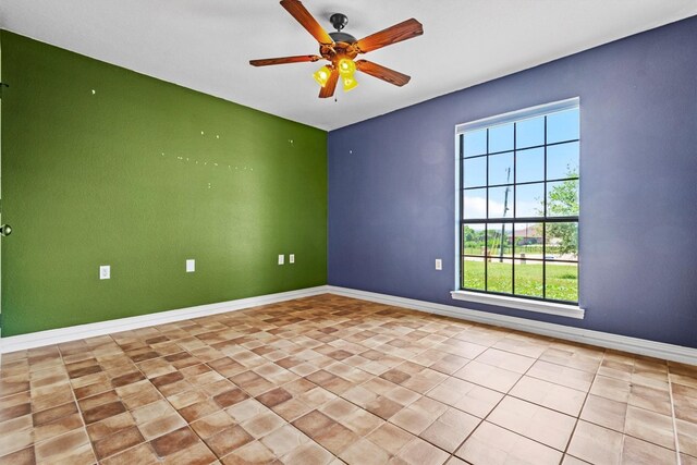 empty room featuring ceiling fan and light tile flooring