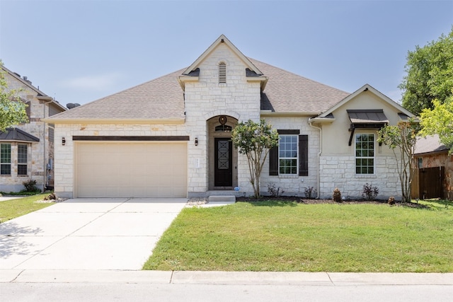 view of front of home featuring a garage and a front yard