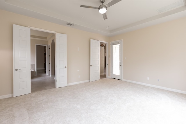 spare room featuring light colored carpet and ceiling fan