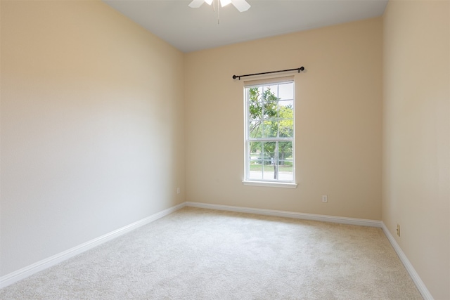 carpeted empty room with a healthy amount of sunlight and ceiling fan