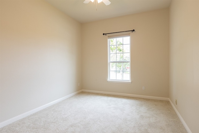 carpeted spare room with a healthy amount of sunlight and ceiling fan