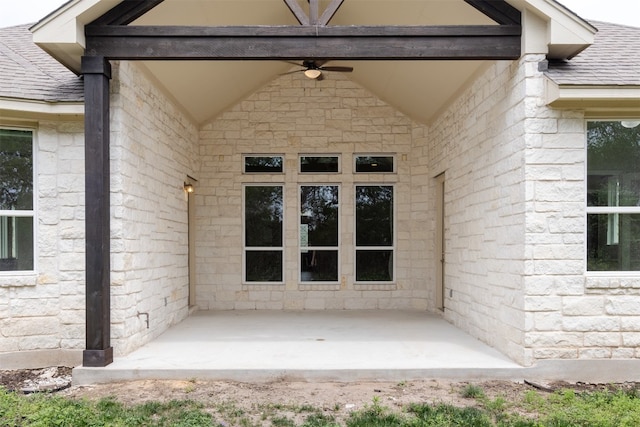 entrance to property featuring ceiling fan and a patio area