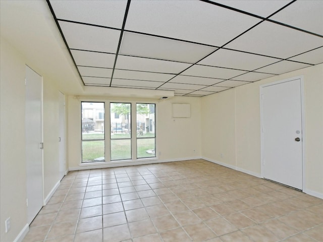 tiled spare room with a paneled ceiling