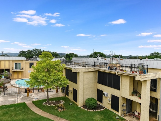 view of building exterior with a fenced in pool