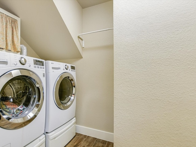 washroom with washer and clothes dryer and dark wood-type flooring