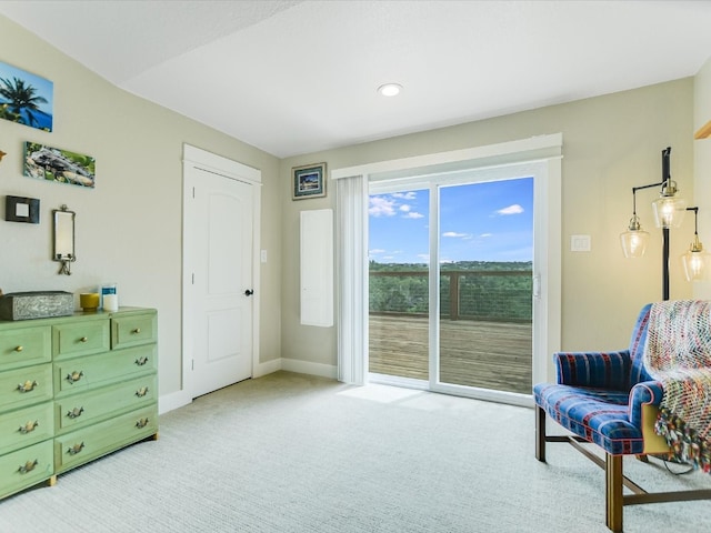 sitting room featuring light carpet