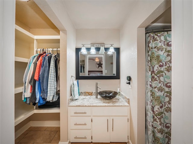 bathroom with tile flooring and vanity